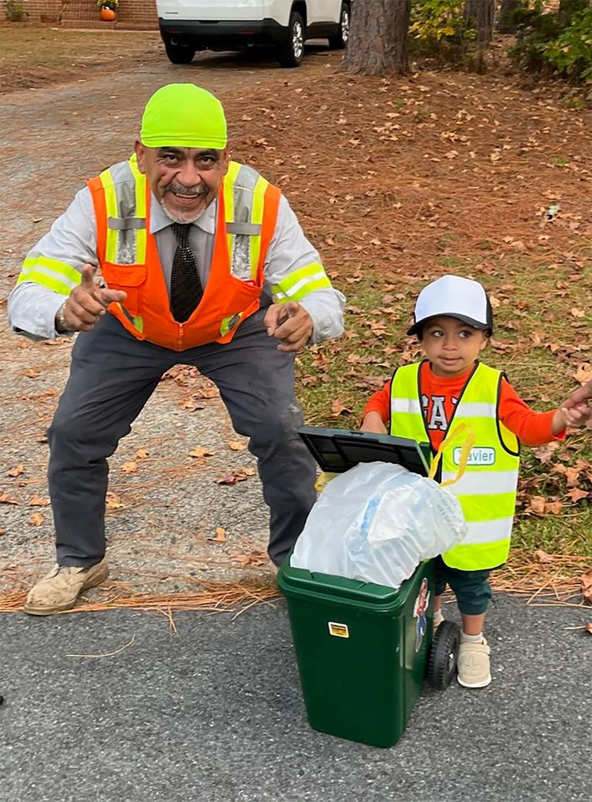 Meridian Waste North Carolina helper Alvero Munoz stops to pose with a young, trash-loving customer who awaits Alvero’s visit weekly